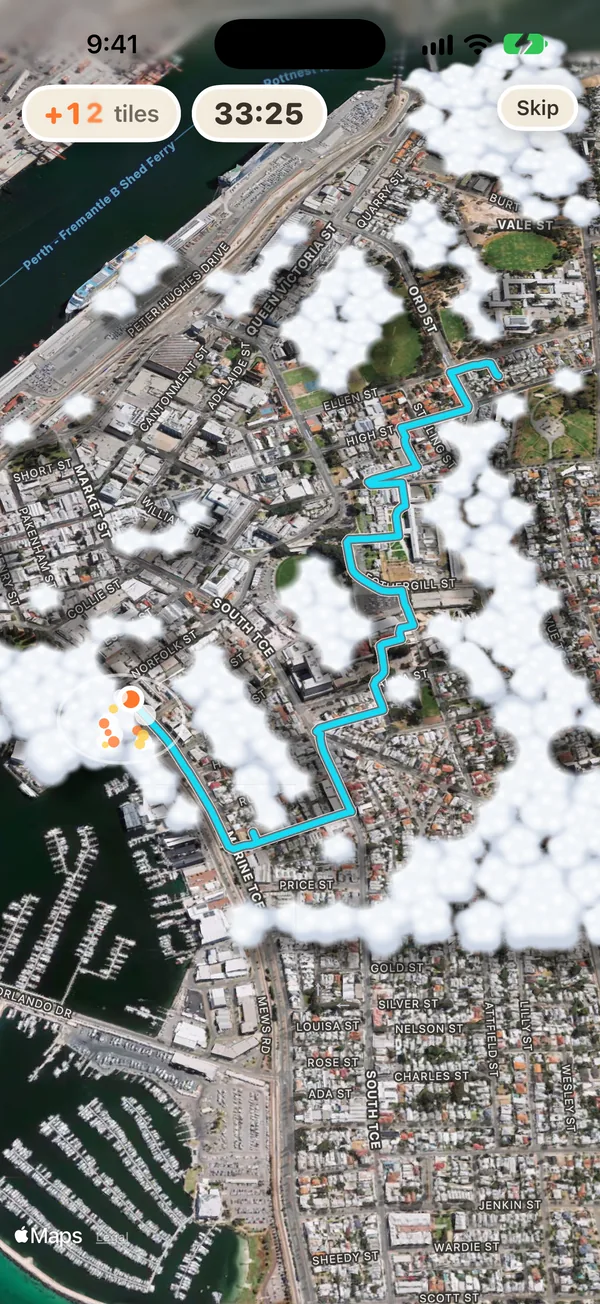 A walk round Fremantle playing back over Apple's satellite map: a teal line along the streets, the clouds cleared off the tiles beside it, and 12 new tiles in 33 minutes 25 at the top